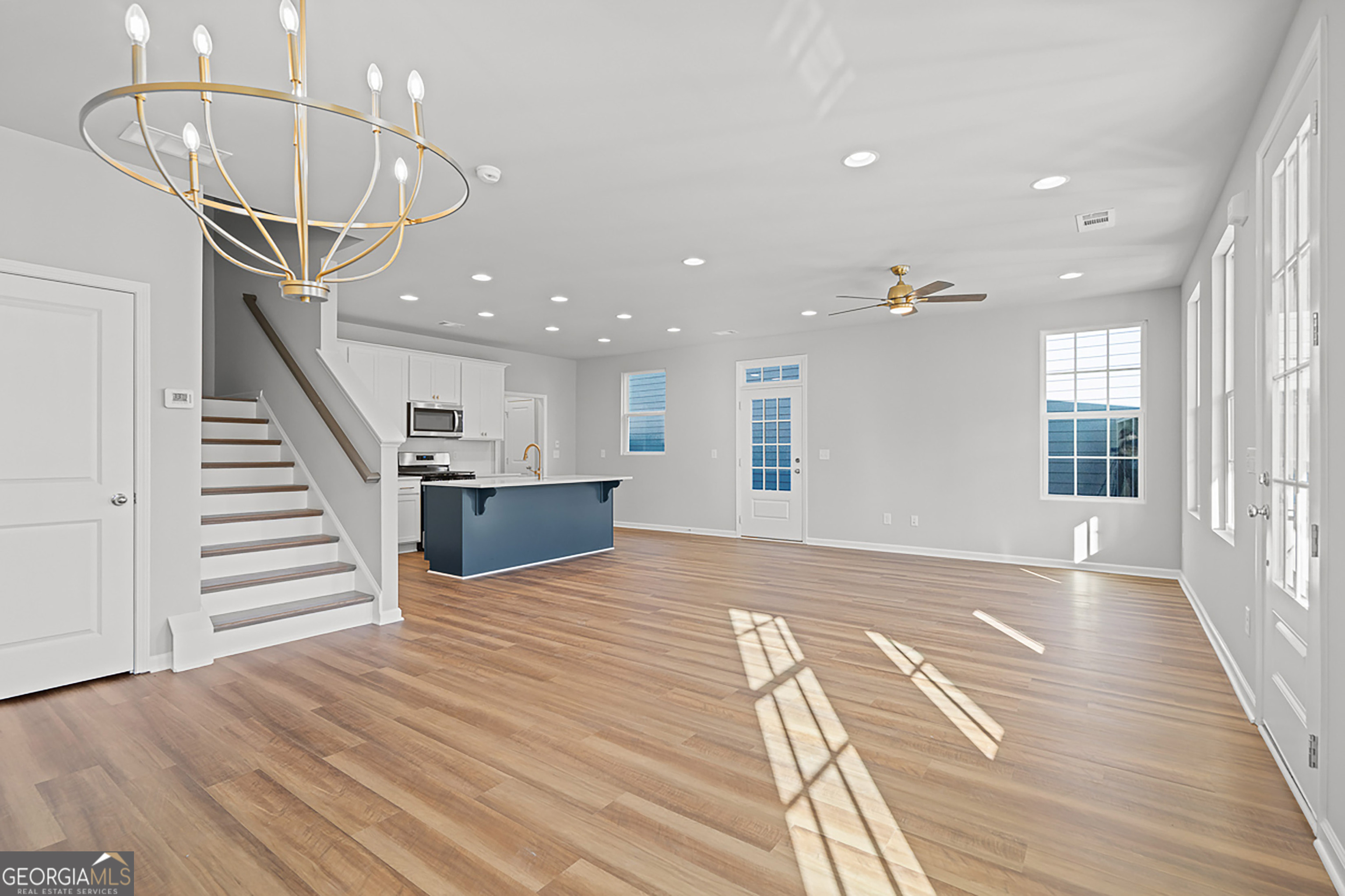 41 Hydrangea Lane, Unit 73 Auburn, GA 30011 - Photo 10 of 30 a view of an empty room with wooden floor and stairs