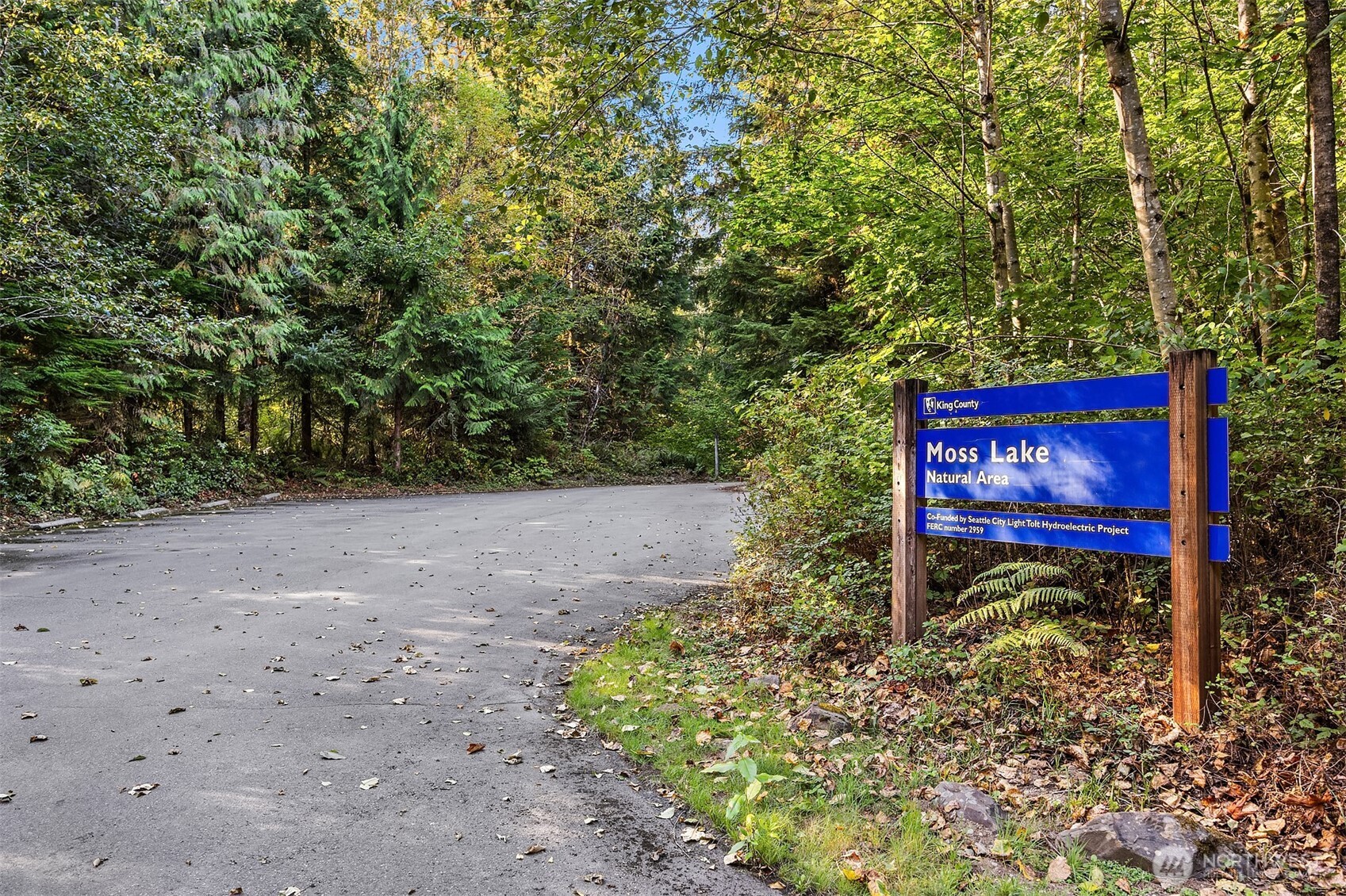 358-xx Northeast Moss Lake Road Carnation, WA 98014 - Photo 23 of 31 a sign board with a bench in the middle