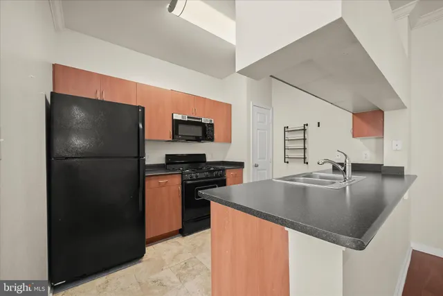 a kitchen with a refrigerator and a stove top oven