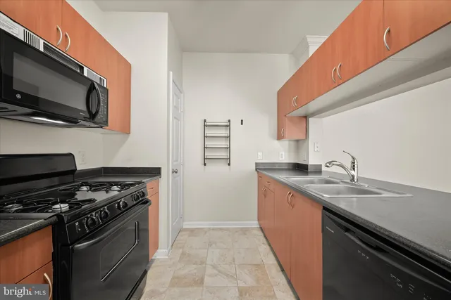 a kitchen with stainless steel appliances granite countertop a stove and a microwave