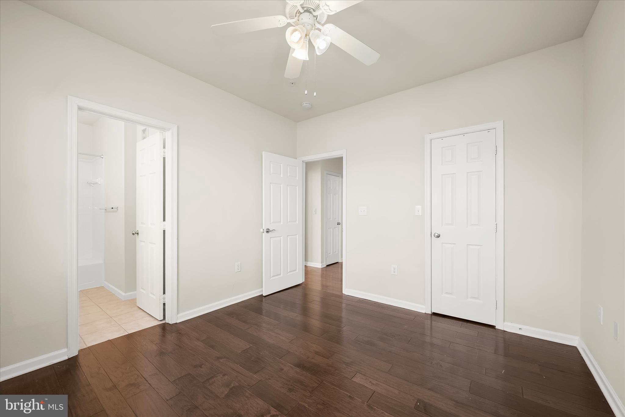 19620 Galway Bay Circle, Unit 302 Germantown, MD 20874 - Photo 19 of 36 an empty room with wooden floor and ceiling fan