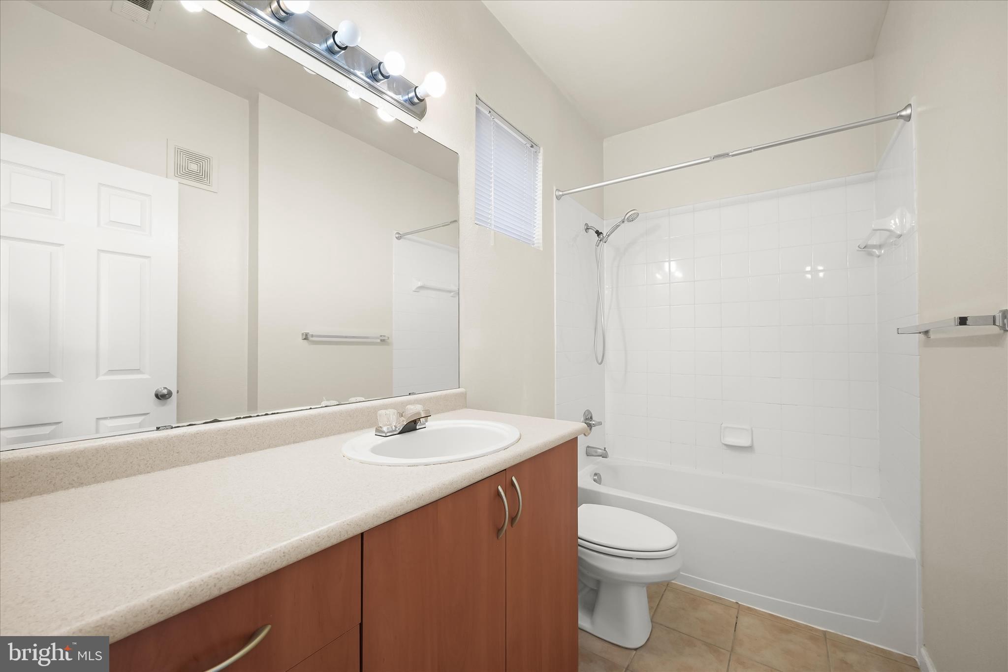19620 Galway Bay Circle, Unit 302 Germantown, MD 20874 - Photo 24 of 36 a bathroom with a sink a toilet and shower