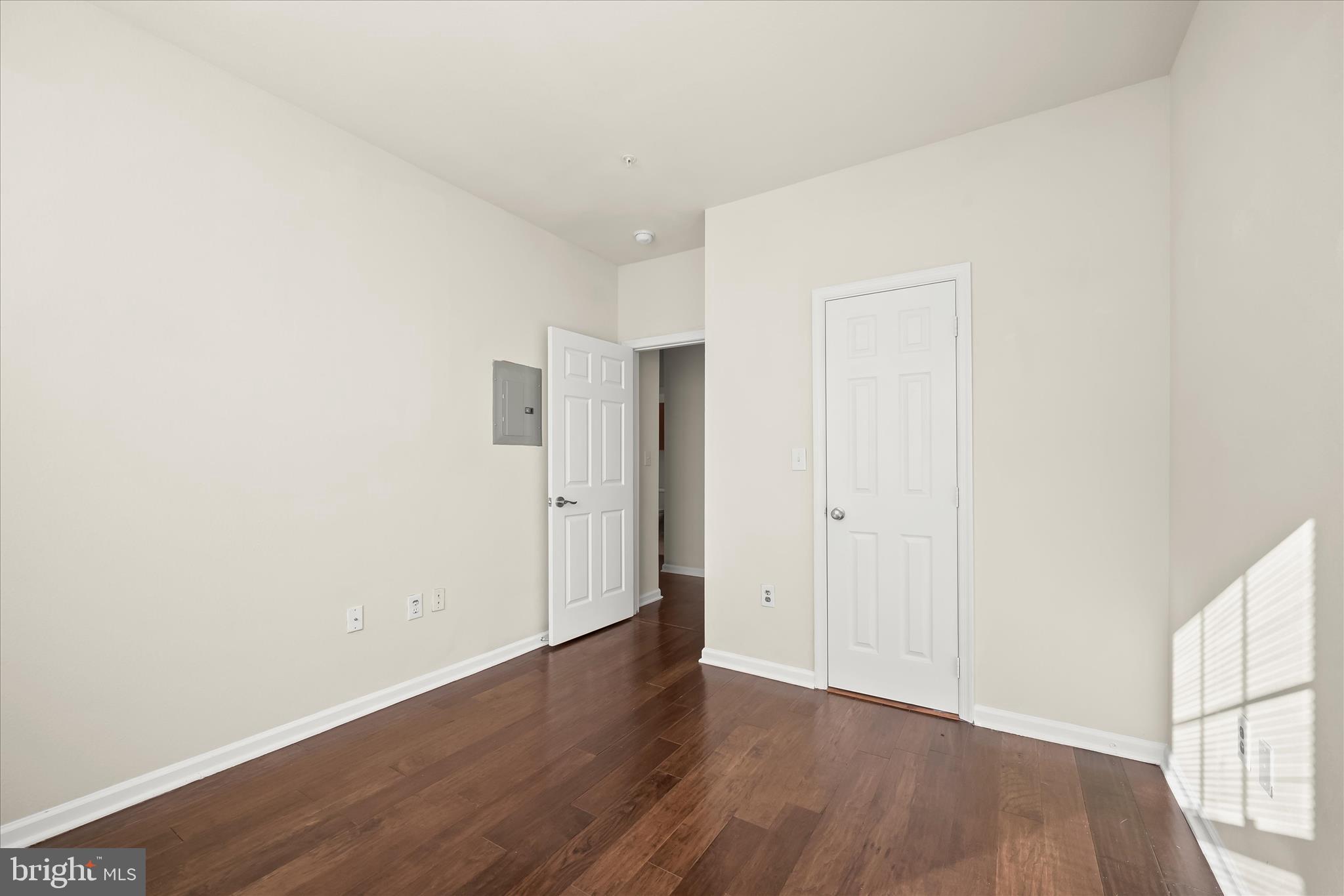 19620 Galway Bay Circle, Unit 302 Germantown, MD 20874 - Photo 27 of 36 a view of an empty room with wooden floor and a window