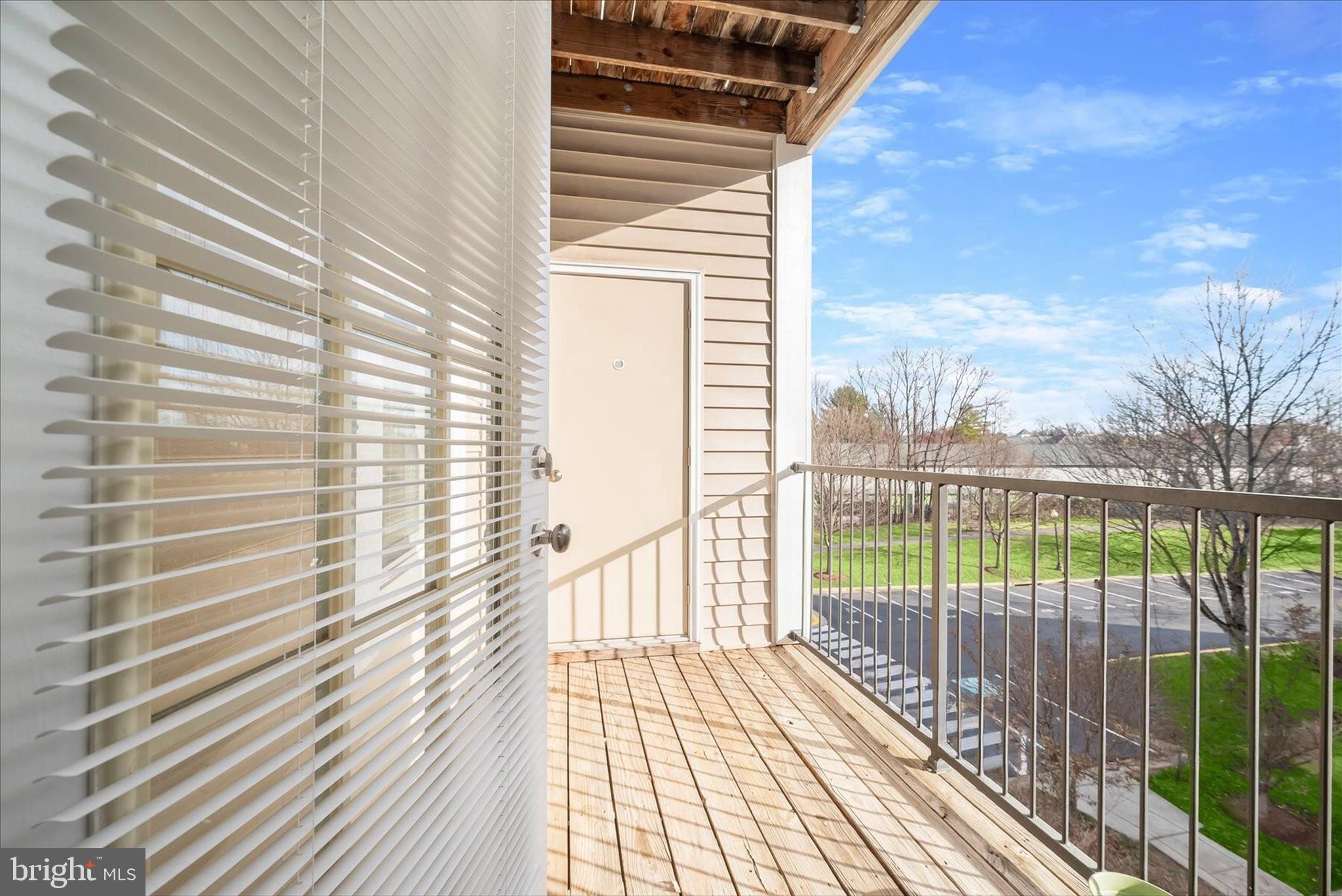 19620 Galway Bay Circle, Unit 302 Germantown, MD 20874 - Photo 33 of 36 a view of a balcony with wooden floor