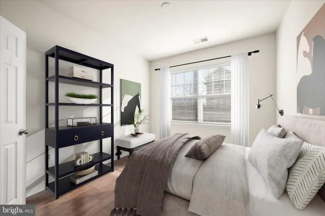 a bedroom with a large bed and a window