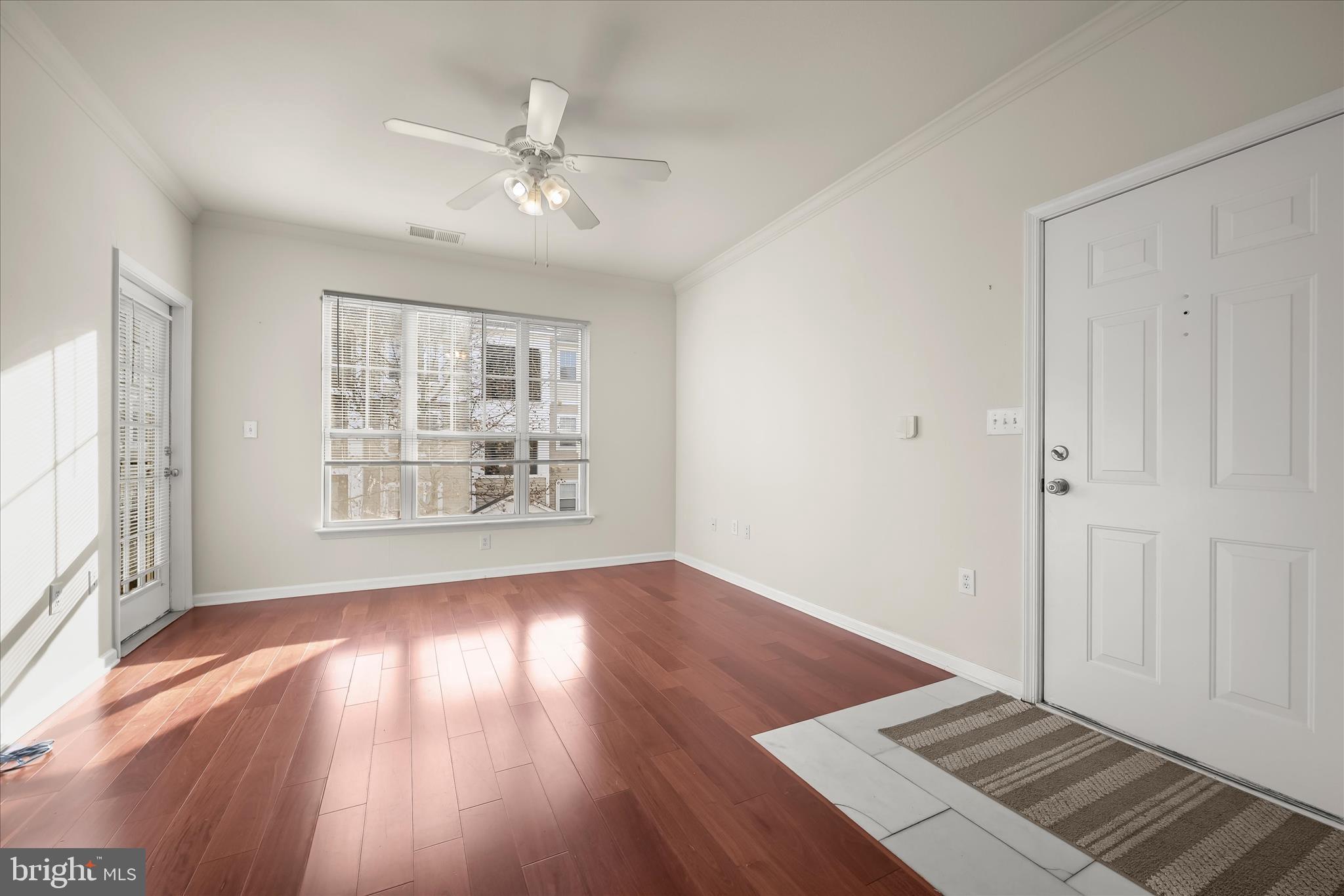 19620 Galway Bay Circle, Unit 302 Germantown, MD 20874 - Photo 6 of 36 wooden floor in an empty room with a window