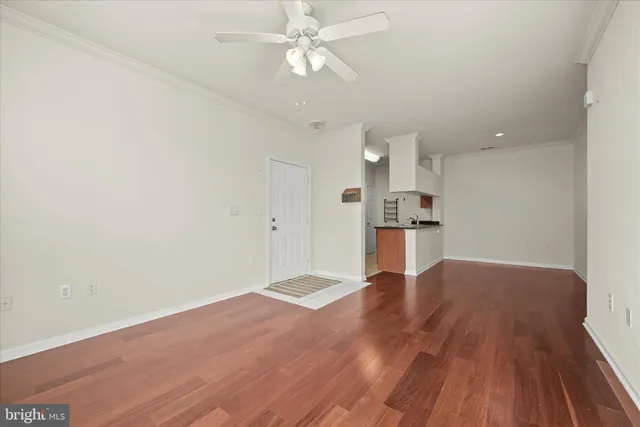 a view of kitchen with wooden floor window and a ceiling fan