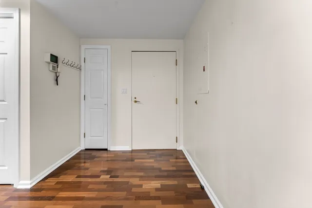 a view of a hallway with wooden floor