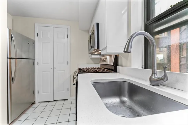 a kitchen with a refrigerator and a sink