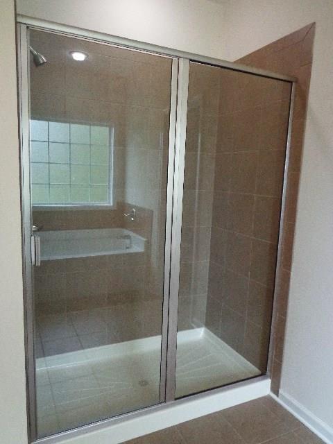 1455 Cliff Amos Road Spring Hill, TN 37174 - Photo 16 of 24 a bathroom with a glass shower door