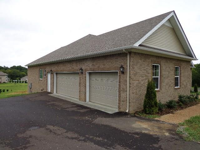 1455 Cliff Amos Road Spring Hill, TN 37174 - Photo 23 of 24 a front view of a house with a yard