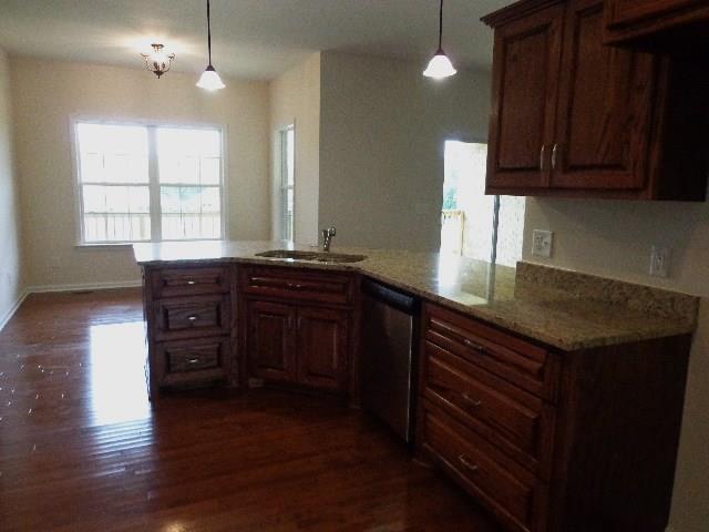 1455 Cliff Amos Road Spring Hill, TN 37174 - Photo 4 of 24 a kitchen with kitchen island granite countertop wooden cabinets a sink and dishwasher