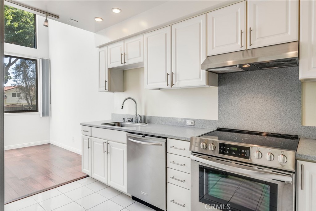 5987 Peacock Ridge Road, Unit 122 Rancho Palos Verdes, CA 90275 - Photo 13 of 31 a kitchen with granite countertop a stove sink and cabinets