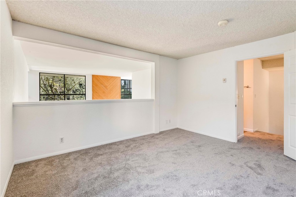 5987 Peacock Ridge Road, Unit 122 Rancho Palos Verdes, CA 90275 - Photo 16 of 31 an empty room with a window