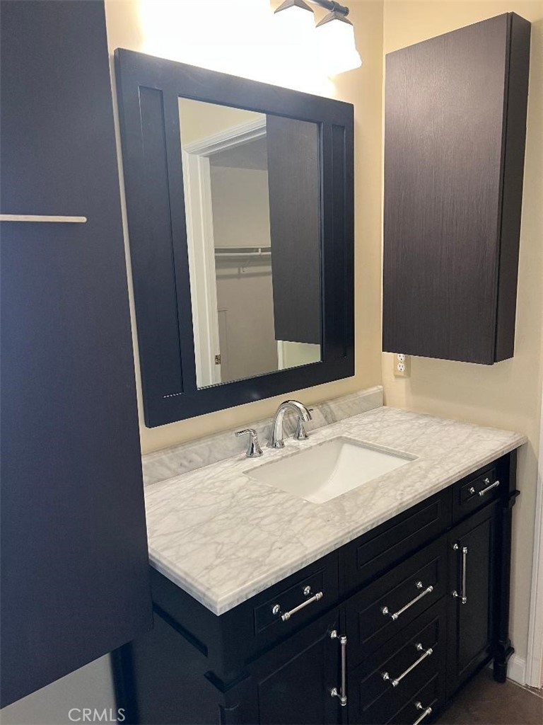 5987 Peacock Ridge Road, Unit 122 Rancho Palos Verdes, CA 90275 - Photo 18 of 31 a bathroom with a granite countertop sink and a mirror