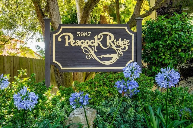 a street sign that is sitting in the middle of flowers