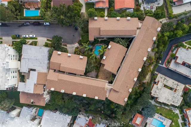an aerial view of a house with outdoor space and a patio