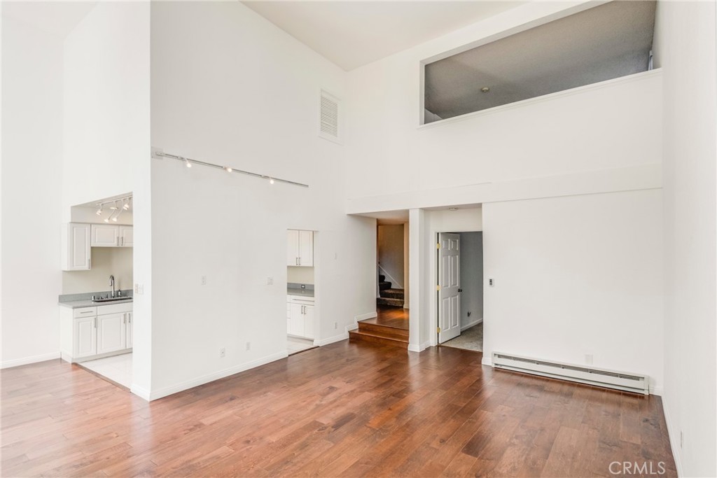 5987 Peacock Ridge Road, Unit 122 Rancho Palos Verdes, CA 90275 - Photo 9 of 31 a view of a hallway with wooden floor and a kitchen