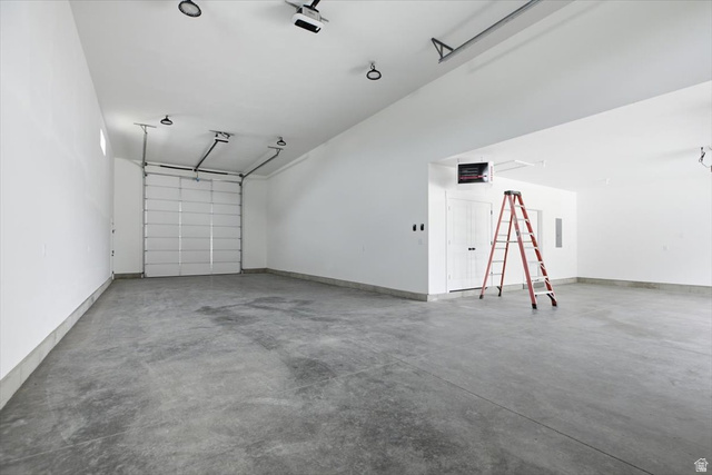 164 North 400 East Preston, ID 83263 - Photo 16 of 21 Spacious garage with a concrete floor, bright white walls, and an overhead garage door