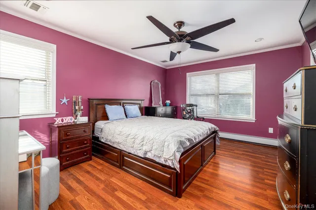 a bedroom with a bed chandelier and a window