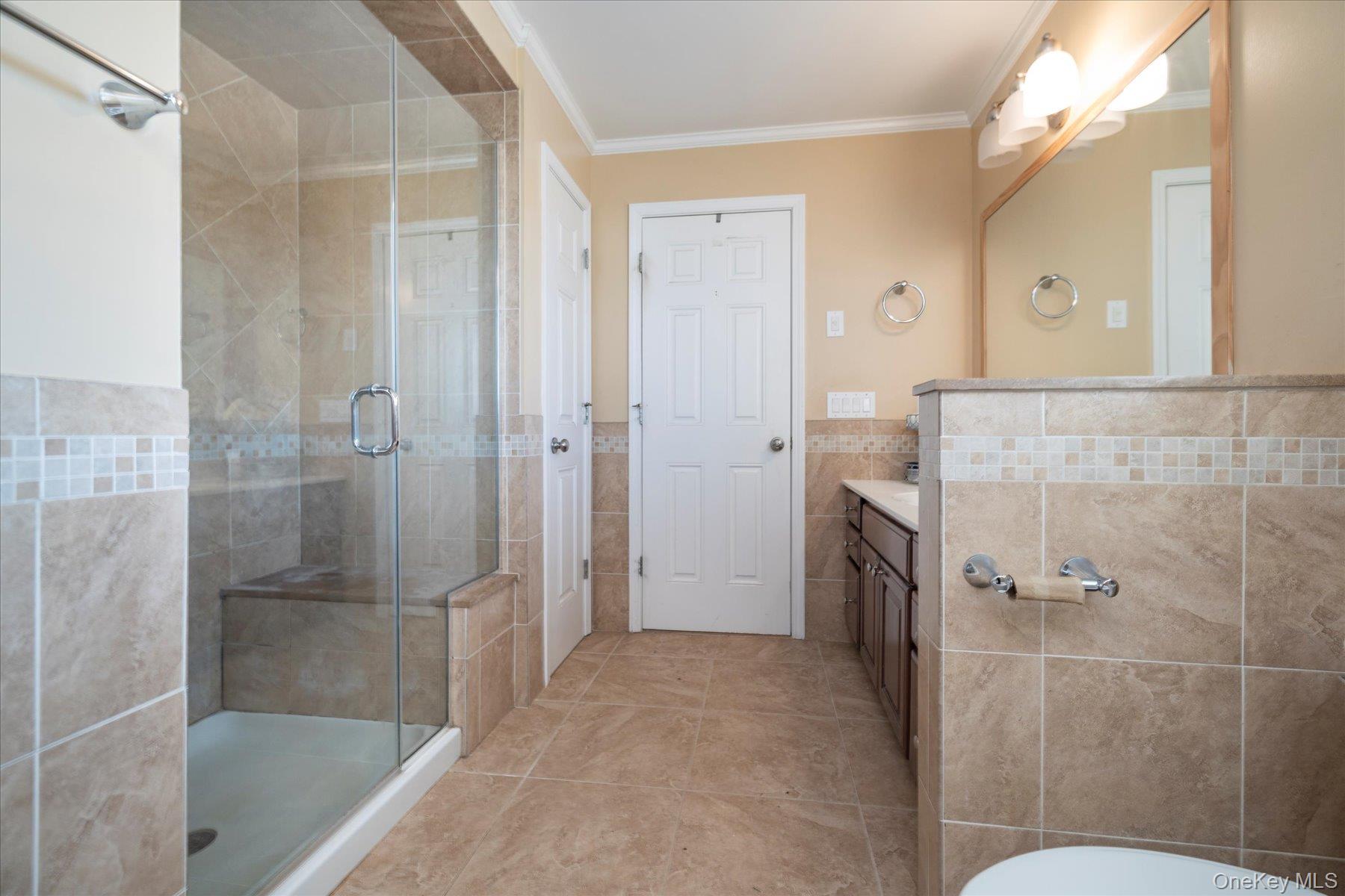 84-24 252nd Street Queens, NY 11426 - Photo 14 of 24 a bathroom with a granite countertop shower mirror and a sink