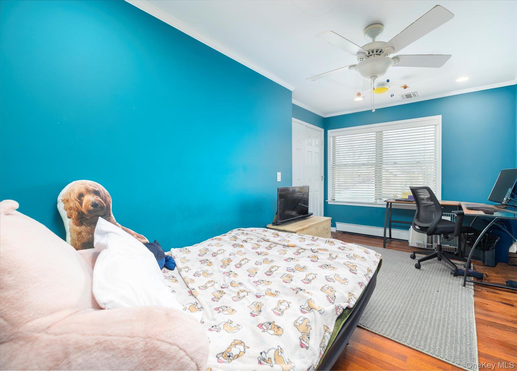 84-24 252nd Street Queens, NY 11426 - Photo 15 of 24 a bedroom with a bed and a chandelier