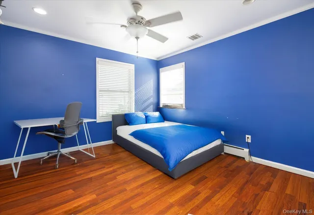 a bedroom with a bed and a desk