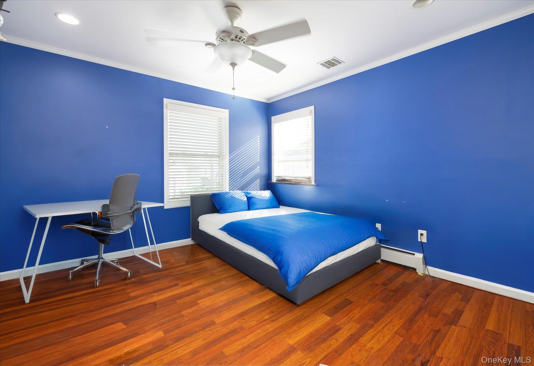 84-24 252nd Street Queens, NY 11426 - Photo 16 of 24 a bedroom with a bed and a desk