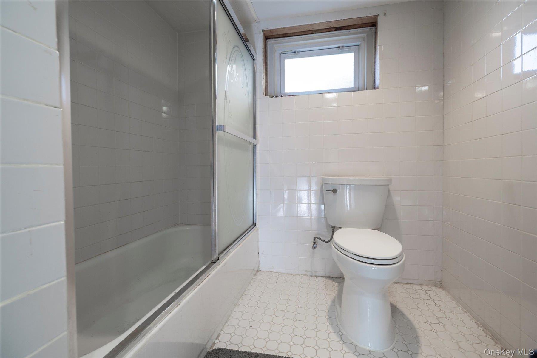 84-24 252nd Street Queens, NY 11426 - Photo 18 of 24 a bathroom with a toilet and a shower