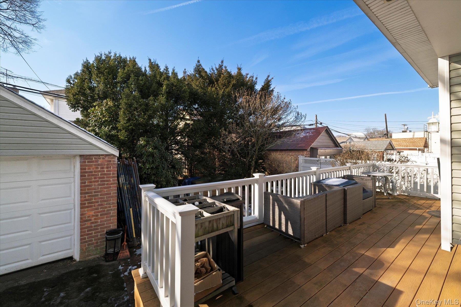 84-24 252nd Street Queens, NY 11426 - Photo 19 of 24 a view of roof deck with wooden floor and fence