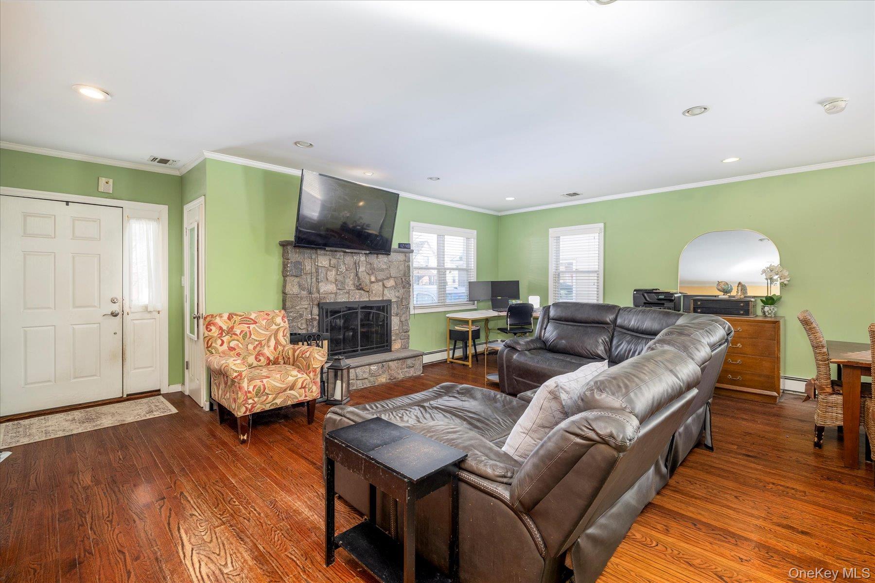 84-24 252nd Street Queens, NY 11426 - Photo 6 of 24 a living room with furniture and a fireplace