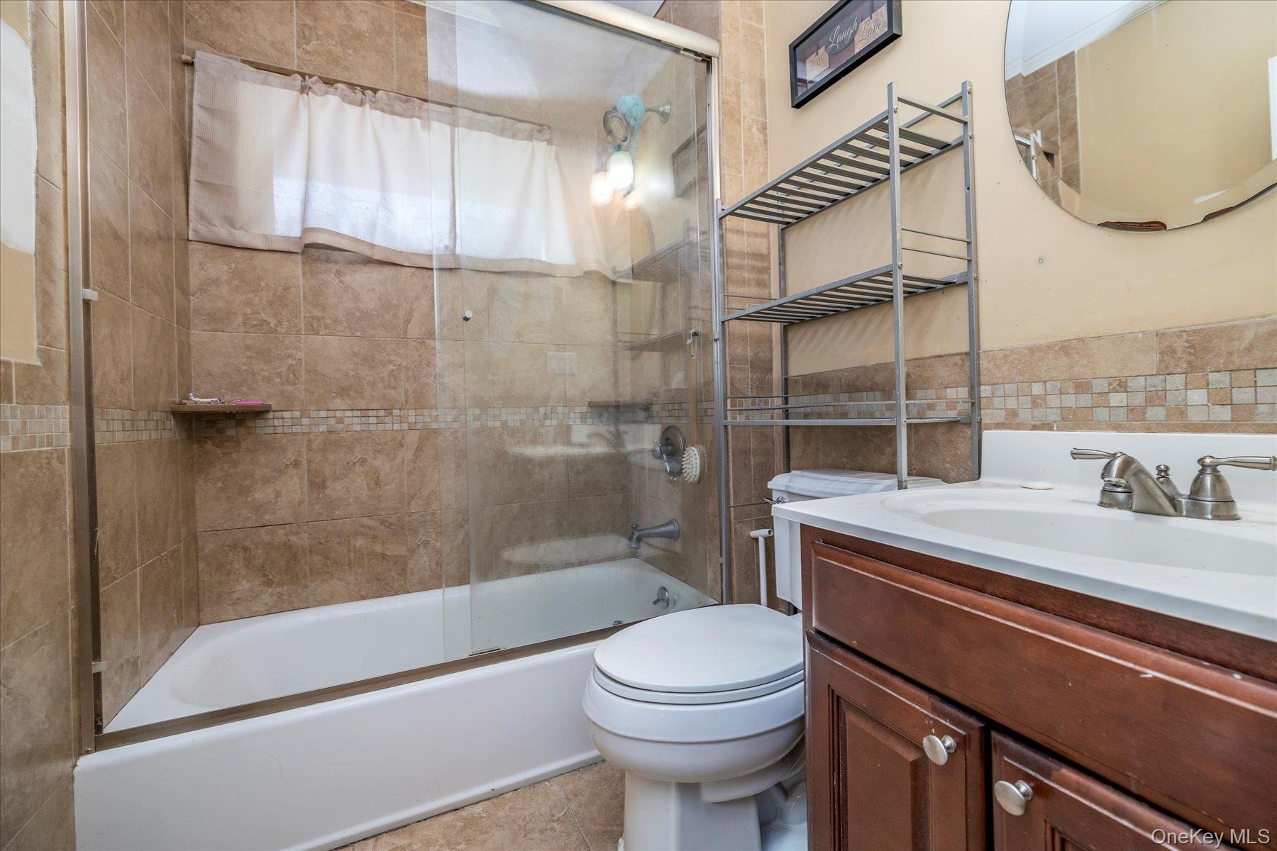 84-24 252nd Street Queens, NY 11426 - Photo 8 of 24 a bathroom with a sink a toilet and shower