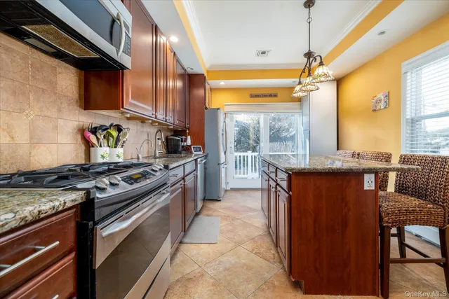 a kitchen with stainless steel appliances granite countertop a stove and a refrigerator