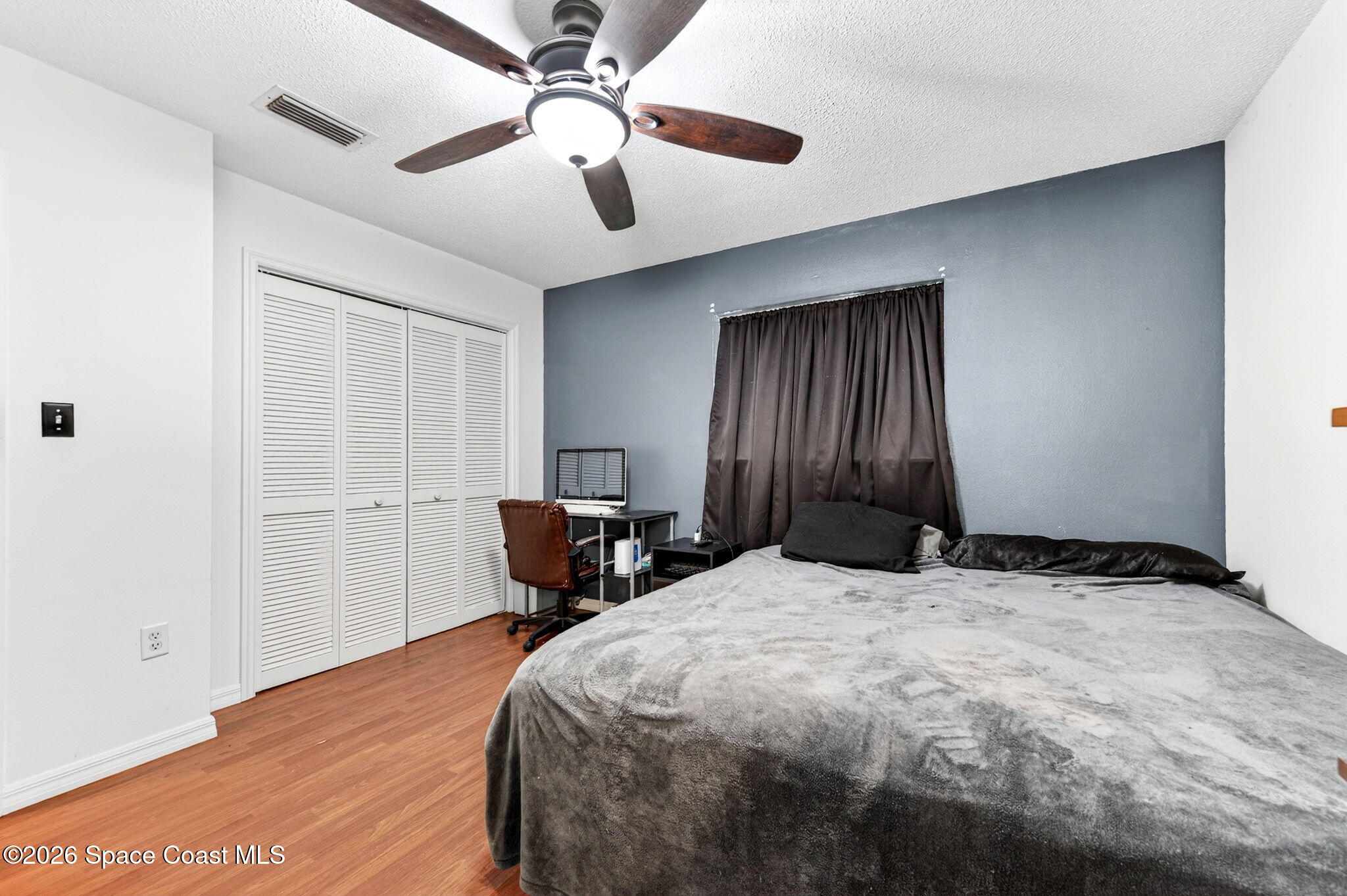 3300 Argyle Road Titusville, FL 32796 - Photo 20 of 29 a bedroom with a bed and a chandelier