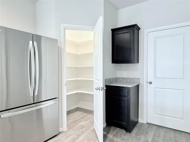 a view of an empty room with a fireplace and a window