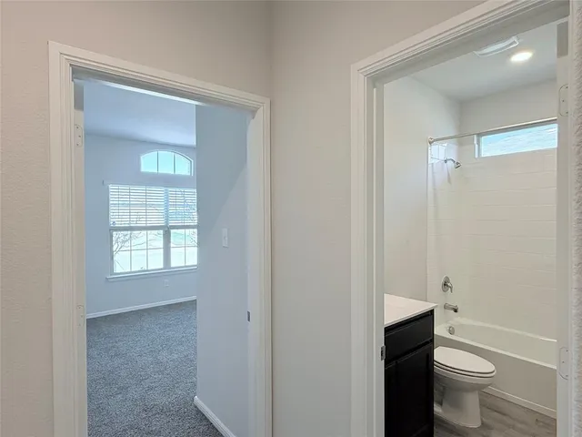 a bathroom with a toilet sink and shower