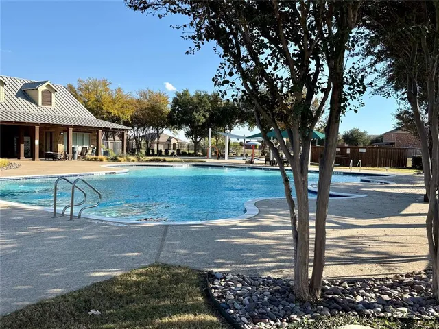 a front view of a building with trees