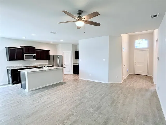 a view of kitchen with stove and microwave