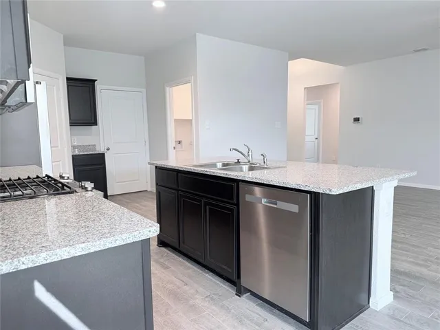 a kitchen with a sink stove and cabinets