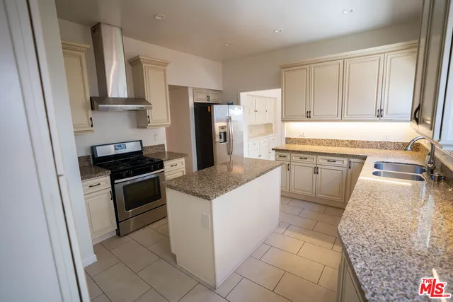 a kitchen with a sink stove and refrigerator