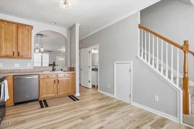 a view of a kitchen with wooden floor and electronic appliances