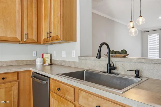 a kitchen with stainless steel appliances granite countertop a sink and a white cabinets