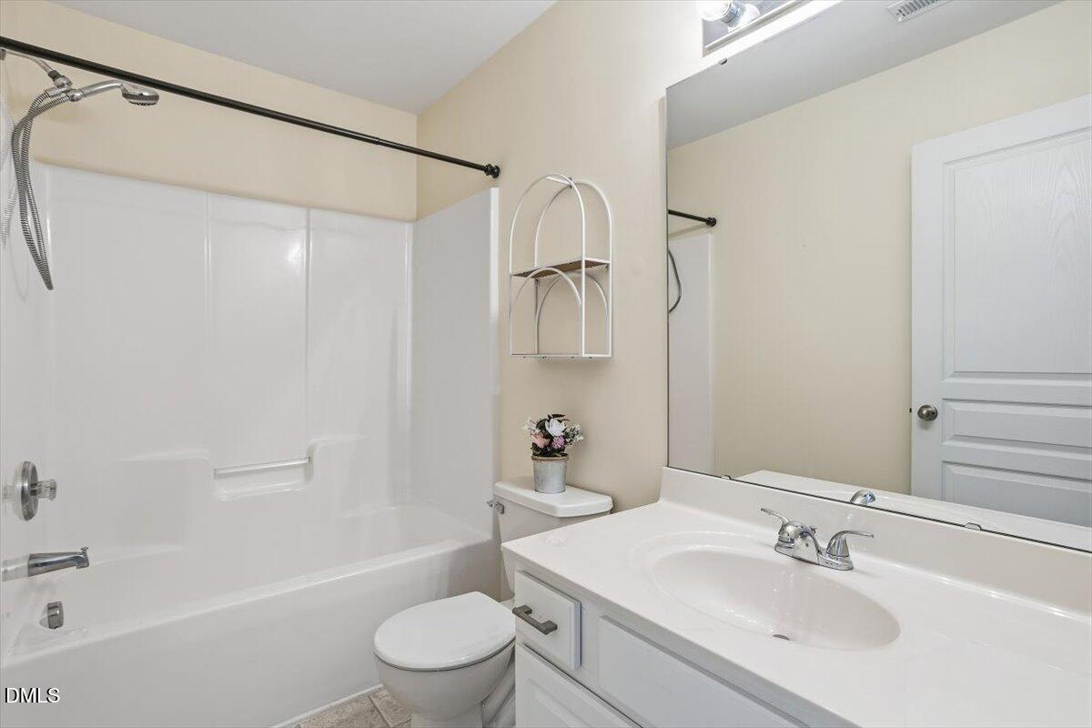 4307 Sugarbend Way Raleigh, NC 27606 - Photo 27 of 35 a bathroom with a sink a toilet and shower