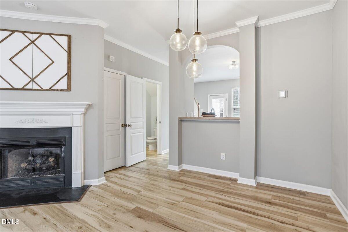4307 Sugarbend Way Raleigh, NC 27606 - Photo 7 of 35 a view of a kitchen with wooden floor and a fireplace