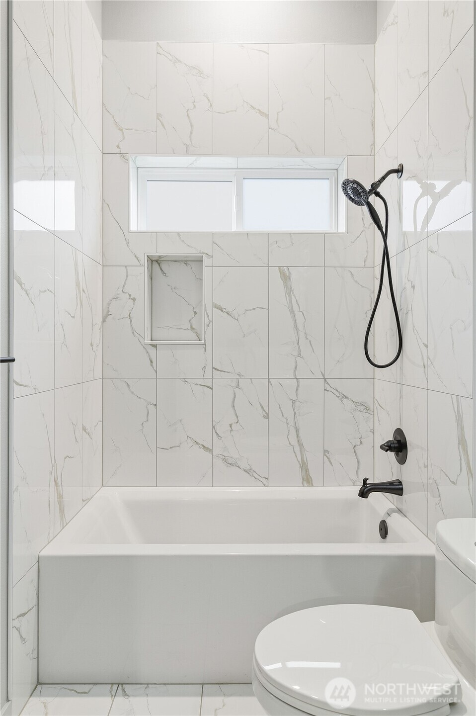 11831 59th Avenue South, Unit B Seattle, WA 98178 - Photo 16 of 19 a bathroom with a toilet a sink and a bathtub