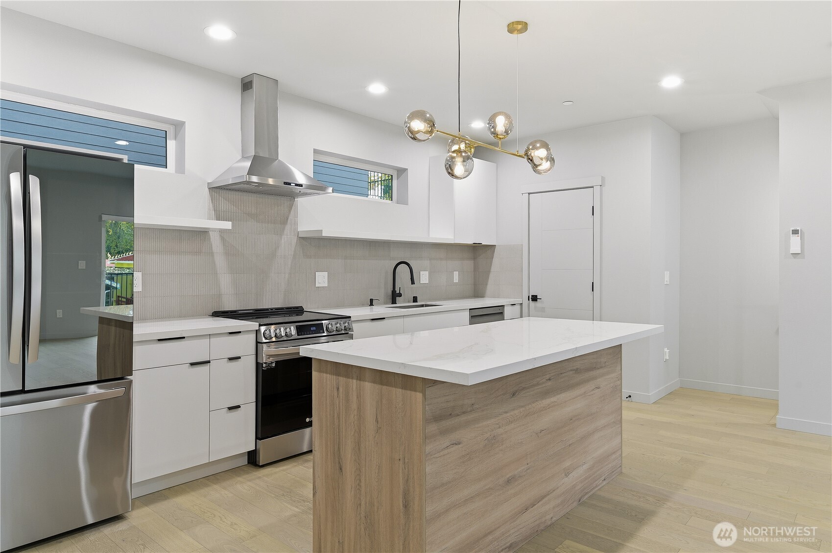 11831 59th Avenue South, Unit B Seattle, WA 98178 - Photo 4 of 19 a kitchen with a stove a sink and a refrigerator