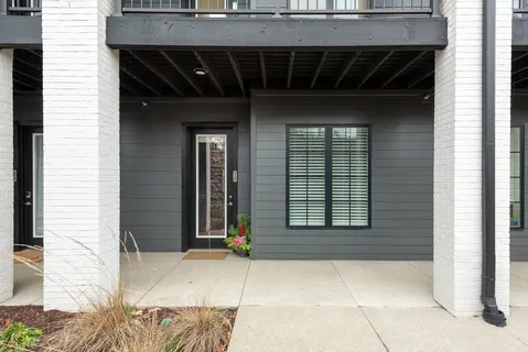 a couple of potted plants in front of door