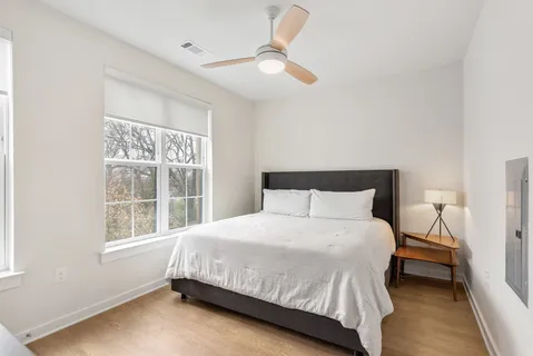 a bedroom with a bed and a window