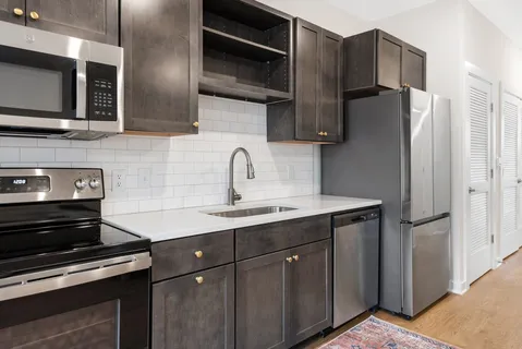 a kitchen with stainless steel appliances a sink stove and refrigerator