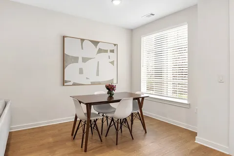 a view of a dining room with furniture and a window
